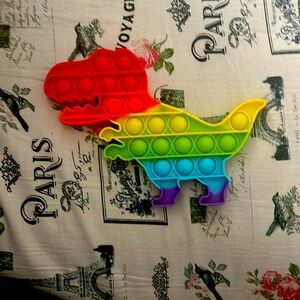 This is a dinosaur pop it toy and it is a fidgeting toy
